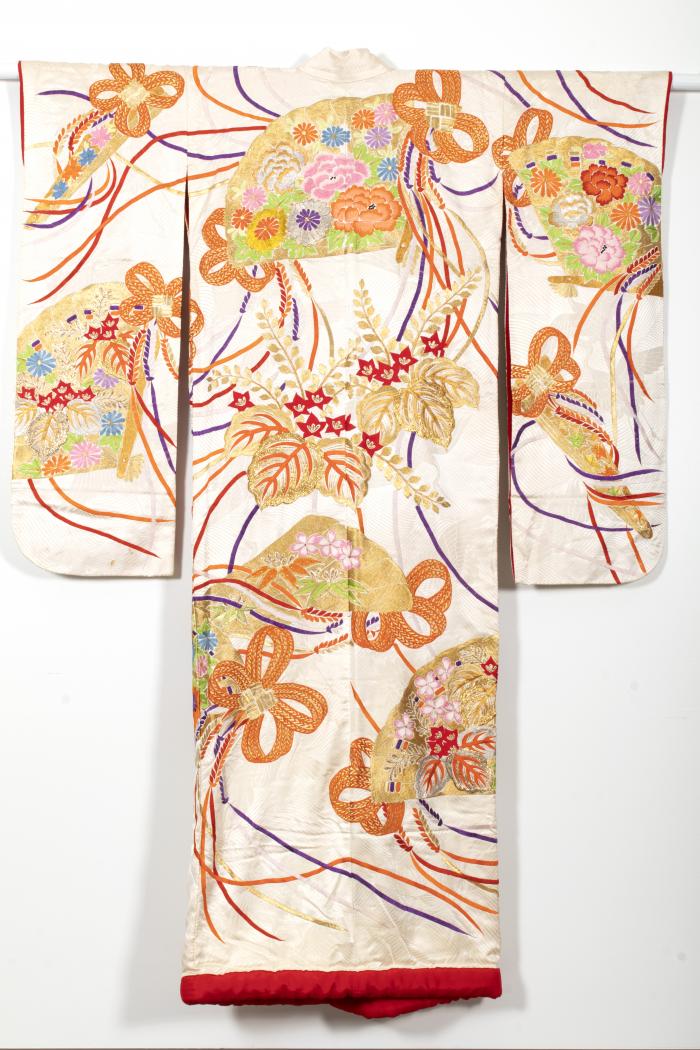 Red ground kimono with gold wave design, embroidered with fans, flocks of cranes, bamboo, cherry blossoms, and Chrysanthemums.
