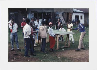 Men Gathered Around Table Tennis Game
