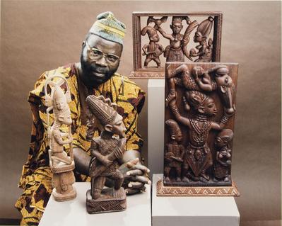 Lamidi Fakeye Posed with Carvings